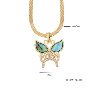 Detail of golden butterfly necklace with green shell wings, 2cm pendant and 45cm chain