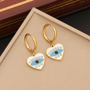 Golden hoop earrings with white enamel heart charms and blue evil eye pattern