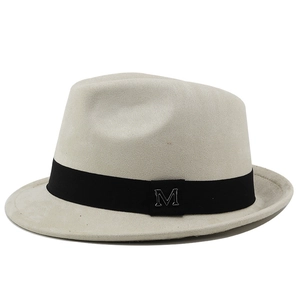 Detailed close-up of grey fedora hat with black band and silver metal M logo
