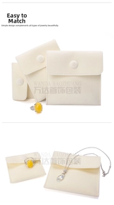 Macro view of cream velvet jewelry pouches with snap button closure for rings and necklaces