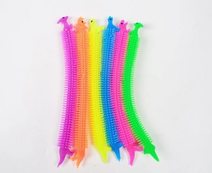 Close-up of 6 colorful sensory fidget dinosaur stretch toys with textured spiky surfaces
