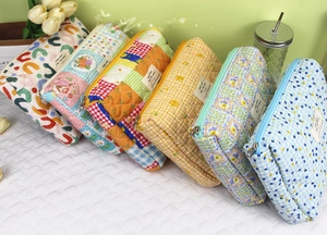 Selection of quilted floral and geometric cotton cosmetic bags in diverse colorful patterns