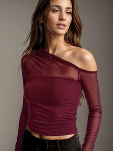Detail of burgundy mesh sleeve stitching and sheer fabric on long sleeve top