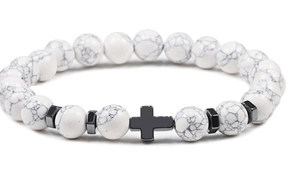 Detail of white marble beads with a black metal cross on a high-quality mens bracelet