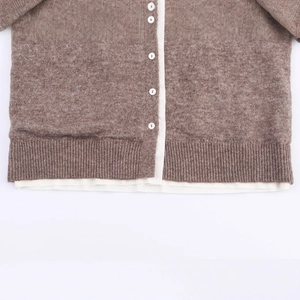 Brown knit cardigan with white contrast placket and white buttons in casual style