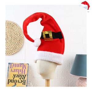 Close-up of red velvet Christmas hat with white fur trim and a golden buckle belt