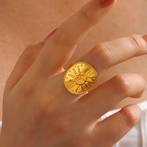 Boho style round sun face relief ring in golden finish worn on finger for women