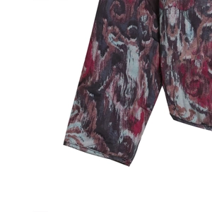 Detail shot of vintage suede jacket featuring vibrant magenta marble print and fine stitching