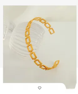 Detail of a hollow rectangular link open cuff bracelet in polished gold finish