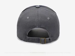 Detail of adjustable bronze metal buckle and washed gray cotton fabric on baseball cap back