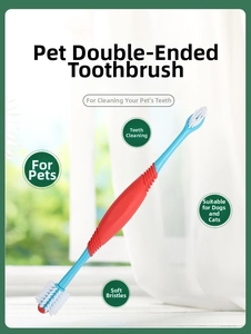 Detailed view of dual-head pet toothbrush with ergonomic handle and soft white bristles