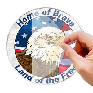 Macro shot showing protective film being peeled off a round patriotic eagle wall plaque