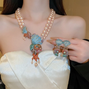 Close-up of vintage shell and star necklace with layered pearls on a model