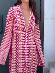 Detail of V-neck crochet dress with colorful geometric patterns and long sleeves
