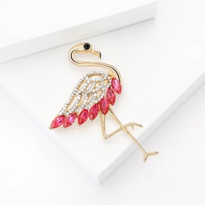 Close-up of a flamingo brooch with crystal rhinestones and red marquise-cut gems