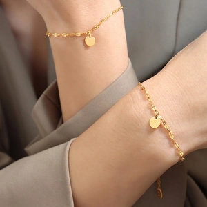 Elegant 18K gold-plated titanium steel bracelet featuring leaf-shaped links and round charms