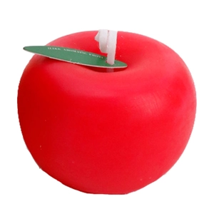 Vela aromática realista con forma de manzana roja y etiqueta de hoja verde