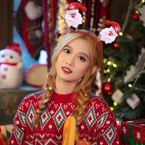 Festive Christmas headband with spring-loaded Santa Claus dolls for holiday party decor