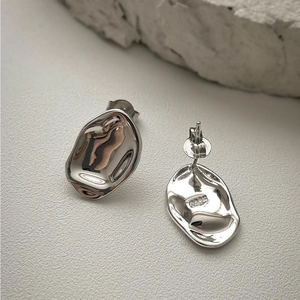 Macro shot of S925 sterling silver irregular molten earrings with hallmark detail