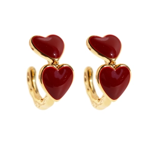 Vintage gold hoop earrings with layered red enamel hearts and textured metallic finish