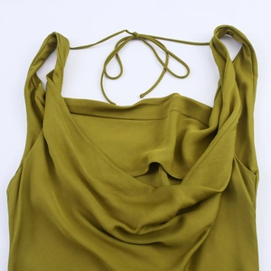 Detail of olive green satin dress with cowl neck and open back spaghetti straps