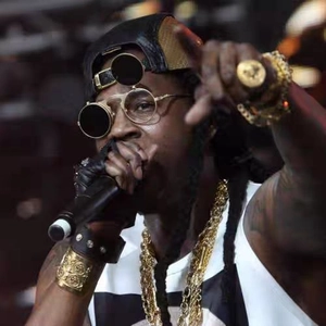 Retro steampunk flip-up round sunglasses with metal frame worn by artist on stage