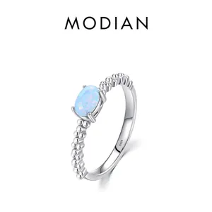 S925 sterling silver ring featuring an oval blue opal stone and beaded band design