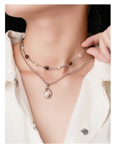 Detail of layered 925 silver necklace with brown tiger eye beads and white pearls