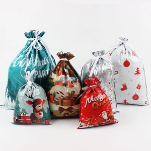 Detail of assorted Christmas drawstring gift bags with festive patterns in multiple colors