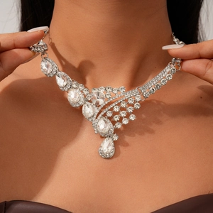 Detailed view of silver teardrop pendant necklace with sparkling white rhinestones