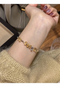 Close-up of beaded citrine bracelet with silver accents worn on a woman's wrist