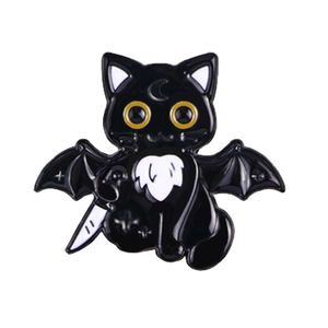 Detailed enamel pin showing a black cat with bat wings holding a sharp dagger
