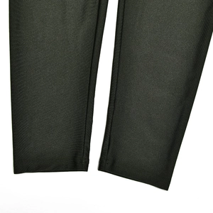 Detail view of the stitching and textured fabric on the hem of black bodysuit trousers