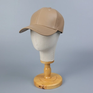 Classic camel PU leather baseball cap with curved brim on a display mannequin