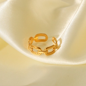 Macro shot of 18K gold plated chain link ring on soft elegant satin background