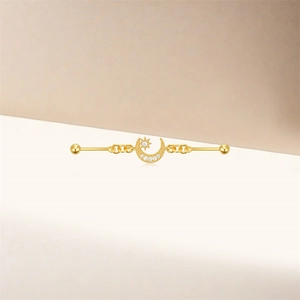 Detail of s925 silver industrial piercing with gold moon star charms and white zircon stones