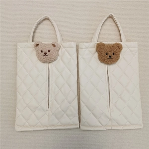 Detail of cream PU leather car tissue holder featuring cute bear patches and quilted pattern