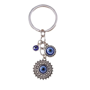 Retro hip-hop style silver keychain featuring multiple blue evil eye sun charms