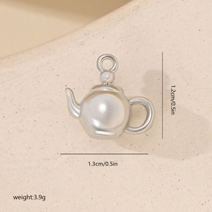 Macro shot of a tiny silver teapot pendant with zirconia and precise size measurements