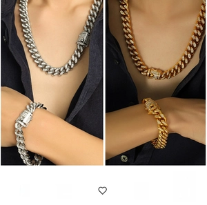 Close-up of iced out Cuban link chain set in gold and silver plating with white zircon