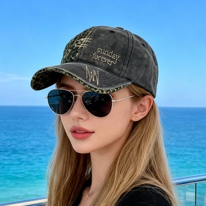 Outdoor shot of vintage washed denim baseball cap with leopard patch and aviator sunglasses