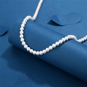 Classic white round pearl necklace for men and women on an elegant blue background