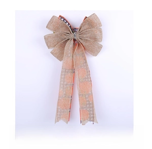 Close-up of harvest burlap bow featuring orange pumpkin patterns and black-white plaid design