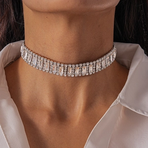 Close-up of a silver geometric choker necklace with sparkling rhinestones on model