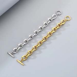Detail view of gold and silver chunky chain bracelets with OT toggle clasps and mirror finish