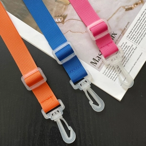 Detail of colorful adjustable nylon straps with white plastic clips for DIY beach bags.