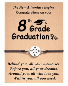 Handmade graduation bracelet with compass charm on a congratulations card for students