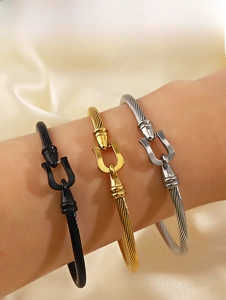 Three-color cable wire bracelets featuring horseshoe buckles on a silk background