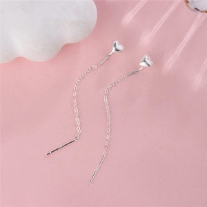 Elegant S925 sterling silver long tassel heart earrings on a soft pink backdrop