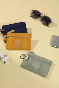 Detail of durable canvas coin purses with metal zippers and key rings in three colors